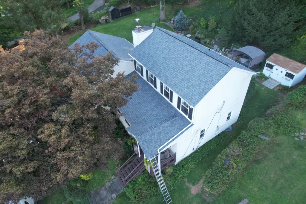 Aerial view of a house with a newly installed grey shingle roof by MoCo